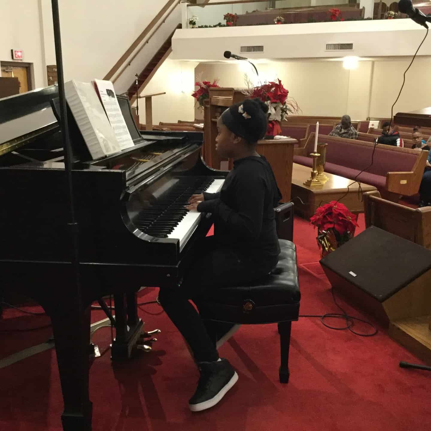 A GEGISOM student playing piano.
