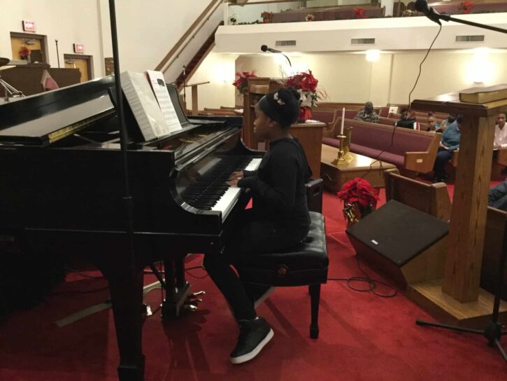 A GEGISOM student playing piano.