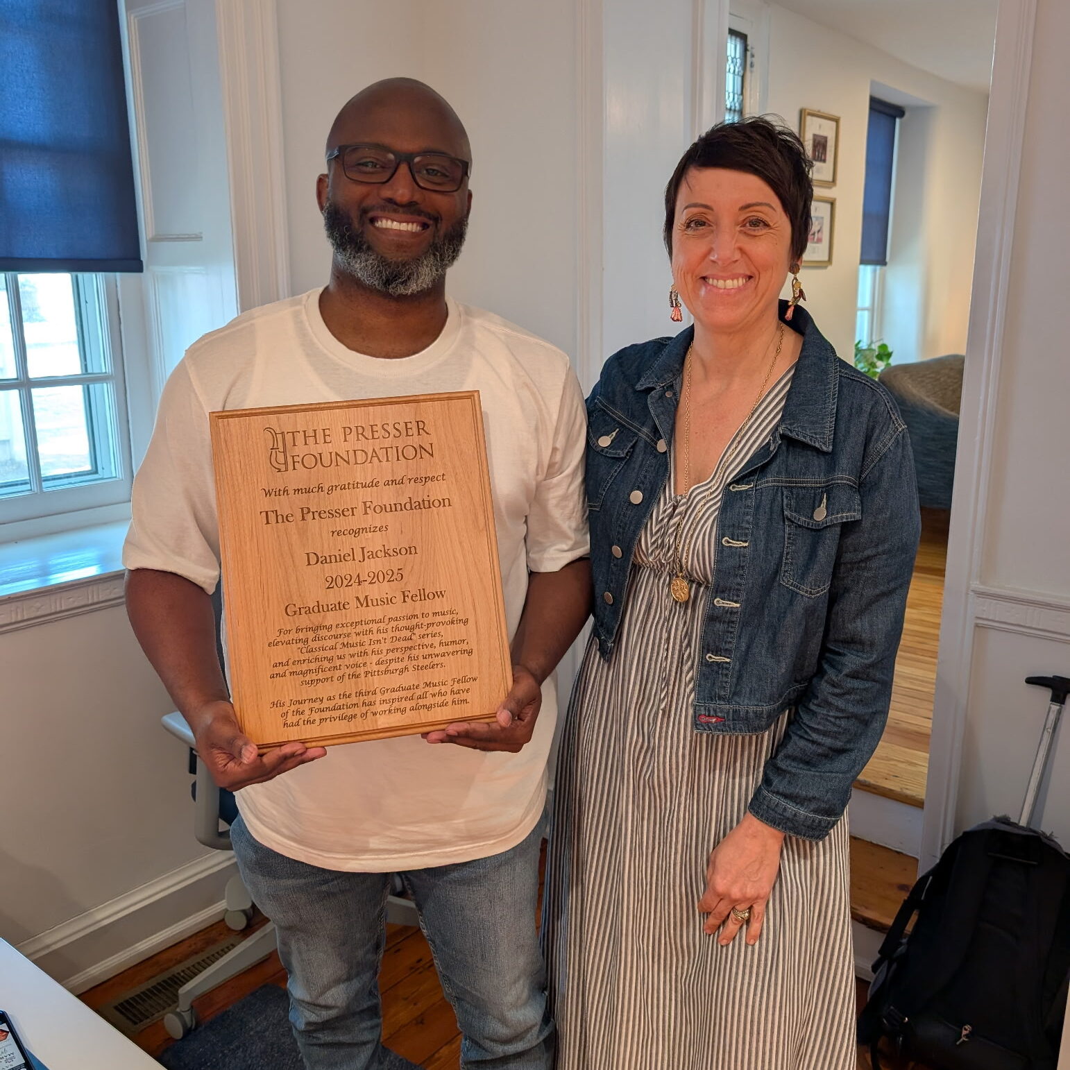 2024-25 Fellow Daniel Jackson receiving his commemorative plaque from Executive Director Teresa Rodgers.